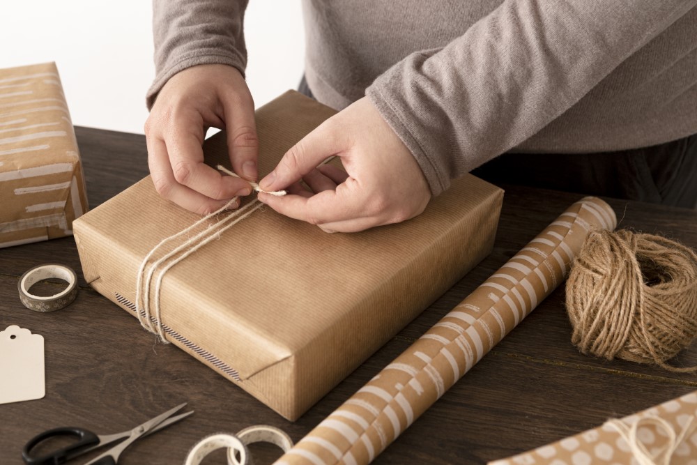person wrapping christmas gift