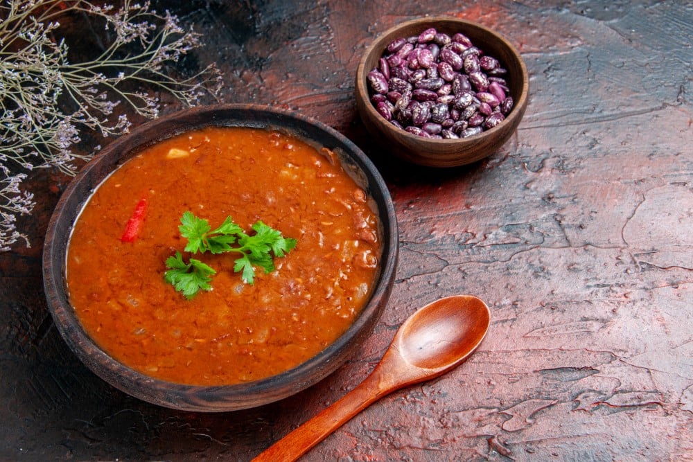 classic tomato soup brown bowl beans spoon mixed color table