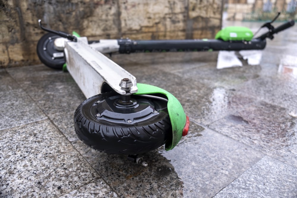 lying electric scooter sharing wet ground cloudy weather bucharest romania
