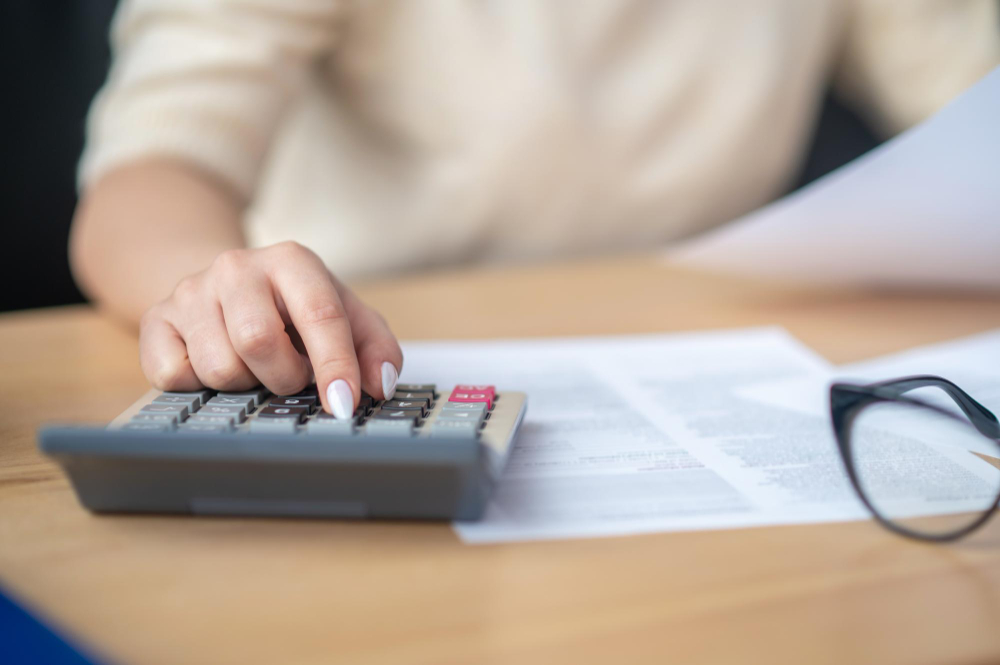 bookkeeper calculating financial budget office desk