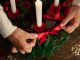 woman assembling holiday themed wreath