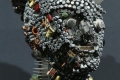 BERLIN, GERMANY - AUGUST 08:  A bust whose surface is completely covered in electronics junk stands at the electronics repair shop owned by Muharrem Batman in Neukoelln disrict on August 8, 2013 in Berlin, Germany. Batman has created a wide variety of busts and even full body sculptures whose outer surfaces are nearly completely covered in electronics capacitors, resistors, bits of circuit boards, CPUs, wiring, keyboards and other scrap he has salvaged from old computers and other devices. Though he says the designs are his own, he admits his sister Ayse and colleague Judith Brun do the much of the actual work. "I just don't have the patience for it, women can do something like that much better," he says. He completed his first piece ten years ago, initially solely with the intent of decorating his store, though he has recently launched a website and hopes to have an exhibition.  (Photo by Sean Gallup/Getty Images)
